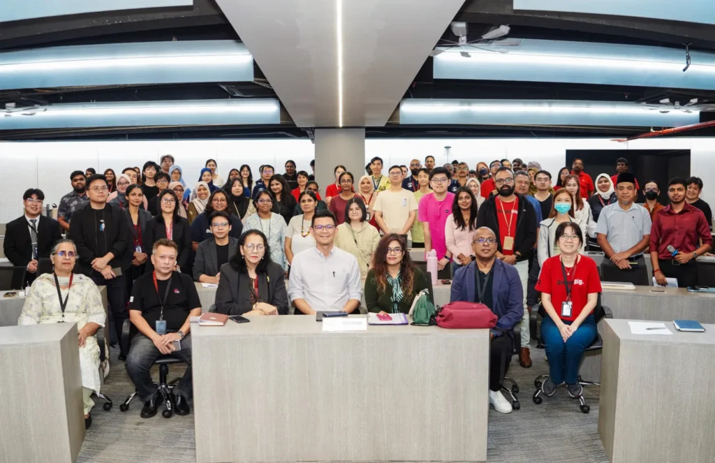 Students and faculty are seated at a panel discussion at Quest International University, engaging in campus conversations about collective action against cyberbullying in a structured approach.