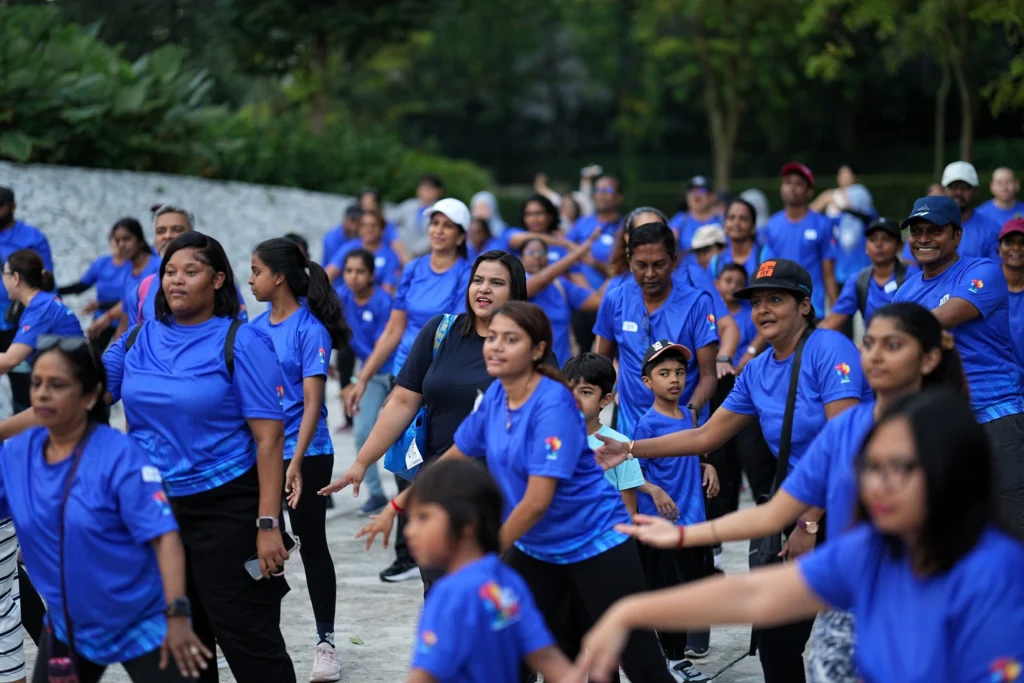 Participants join a guided warm-up session before the Walk for Autism community walk.