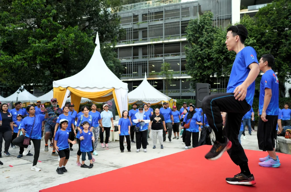 Fitness instructors lead participants through a warm-up exercise session at the event.