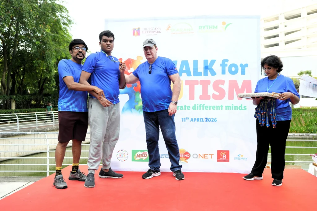 A child receives recognition during the prize presentation session at Taarana’s Walk for Autism.