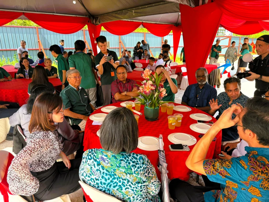 Guests and project stakeholders engage in discussion during the Site Work Commencement Ceremony for the QIU new campus project.