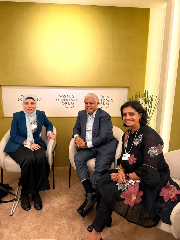 Vijay Eswaran and Umayal Eswaran meet with a fellow delegate during AMNC26 in Dalian.