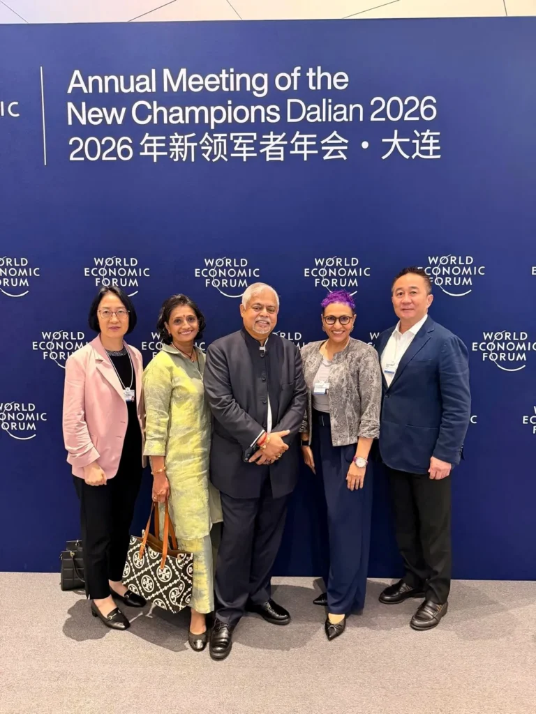 QI Group senior leaders attend AMNC26 in Dalian, with Vijay Eswaran joined by Umayal Eswaran, Cathy Zhou, Ramya Chandrasekaran and Nicholas Goh.