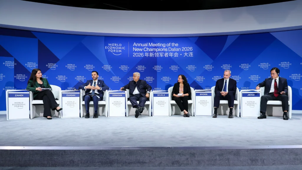 Vijay Eswaran joins global leaders on stage for The Next Billion Jobs panel at AMNC26 in Dalian.